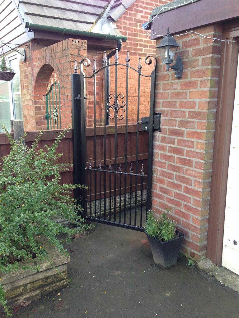 Wrought iron gate on left of property