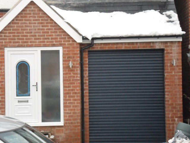 Front garage door and porch door along with downpipe in place.