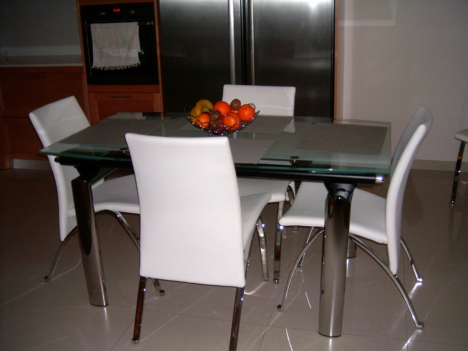 This is the new extendable glass table. you can also see the newly installed ceramic floor tiles.I removed the old tiles and installed the new ones myself.